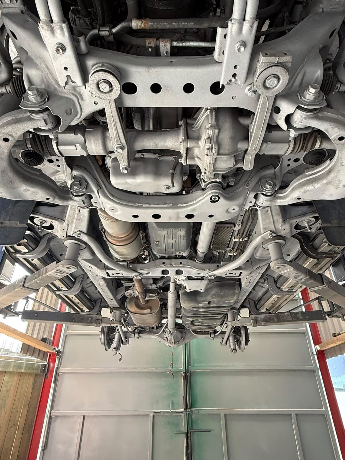 The same front subframe, arms and floor pan after shotblasting and coating