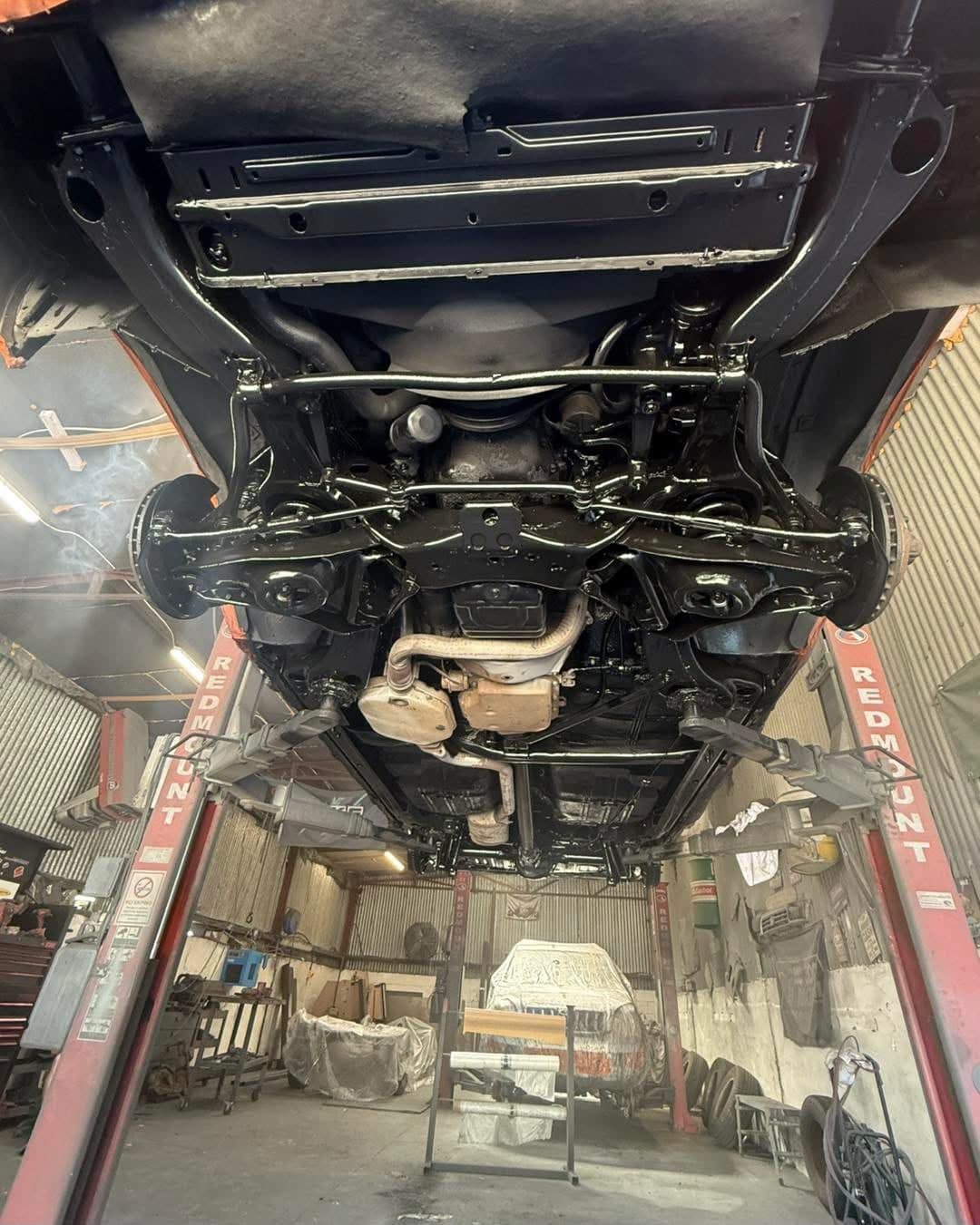 Restored classic car underside finished in gloss black