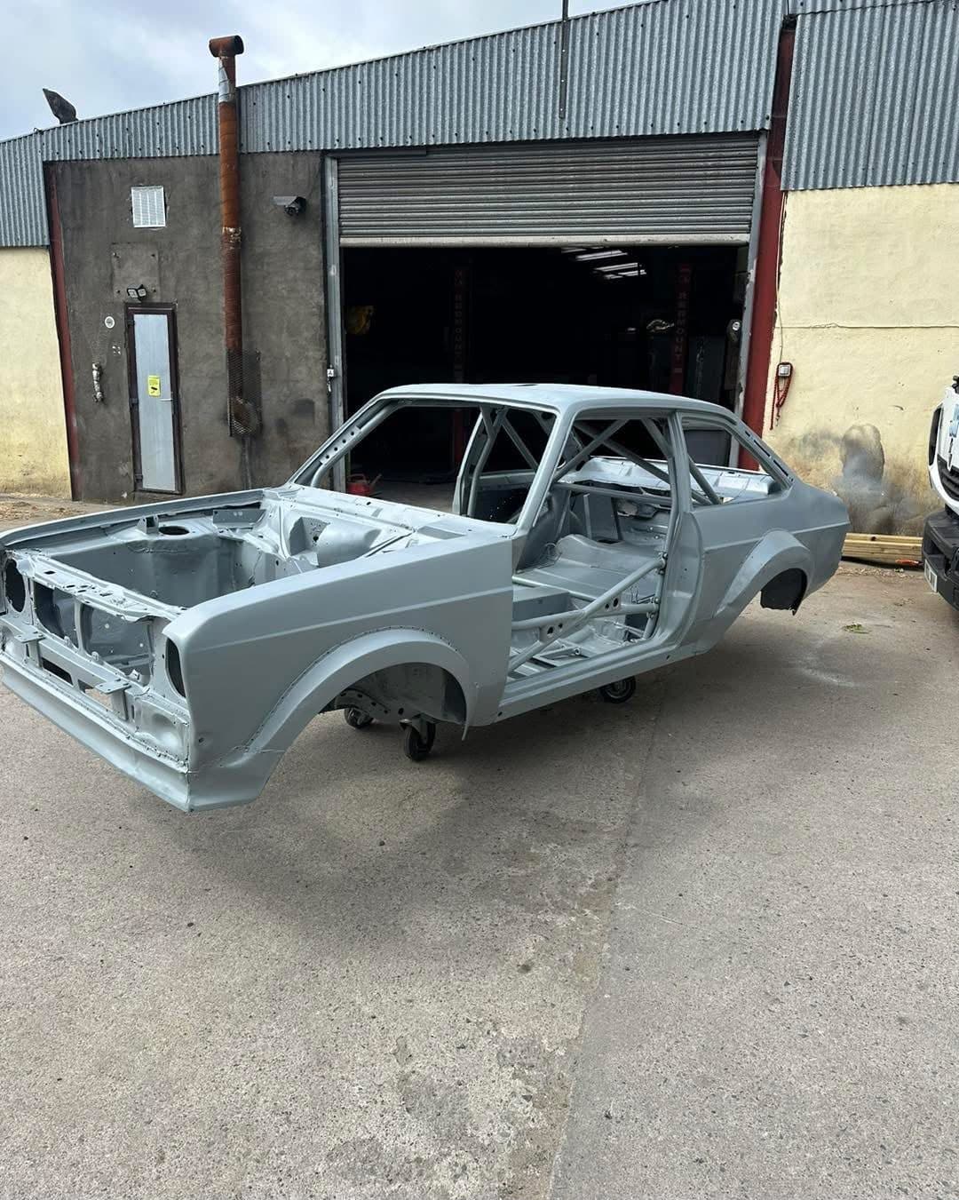 Caged Mk2 Ford Escort shell in grey primer