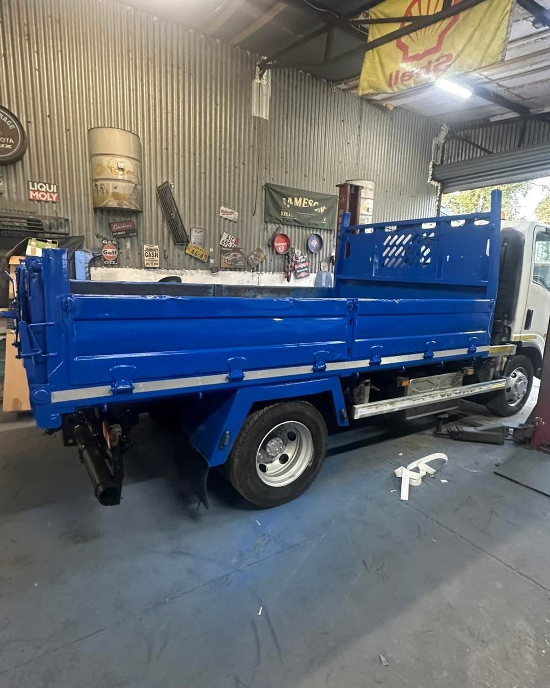 Repaired tipper body resprayed in fresh blue in the workshop