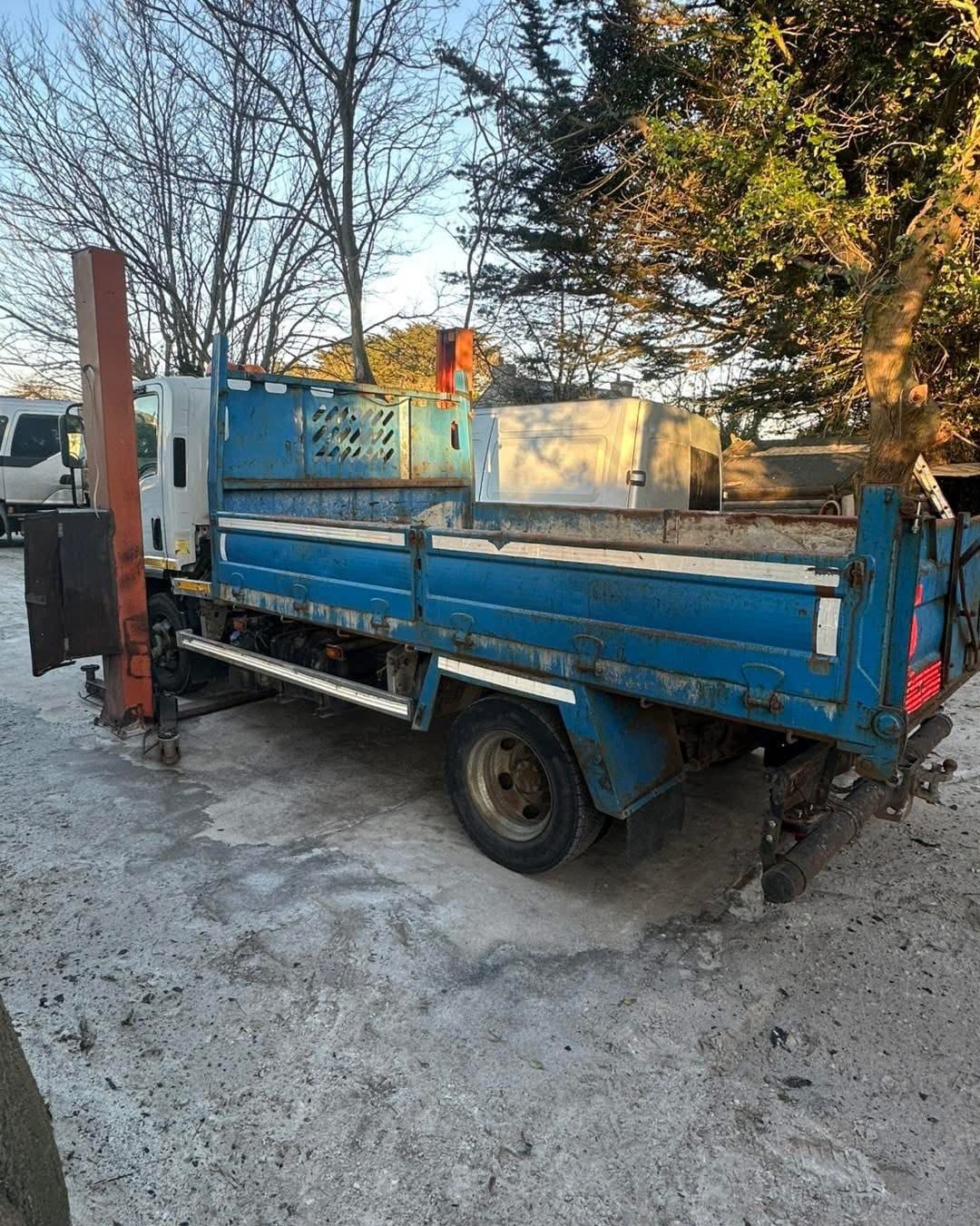 Blue tipper body with faded paint and corrosion before refurbishment